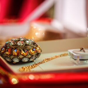 Close-up of a luxurious jewelry box with exquisite gold and jeweled accessories in an elegant display.